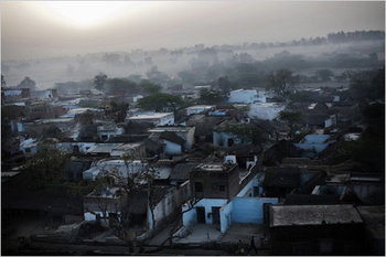 The village of Pipal Kheda, India, with a haze from early-morning cooking fires. by Adam Ferguson for The New York Times